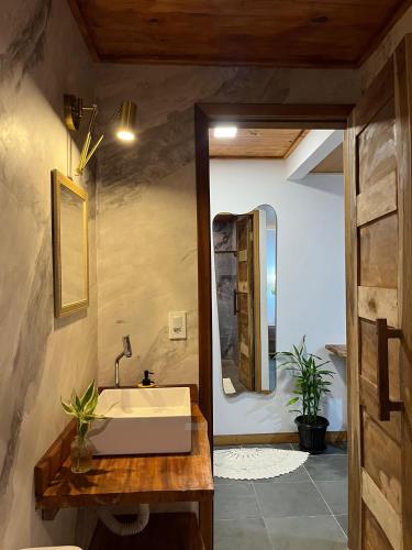 a bathroom with a sink and a mirror at Casa bambu atins in Atins