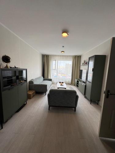 a living room with a couch and a table in it at Cozy Apartment newly furnished in Ulaanbaatar