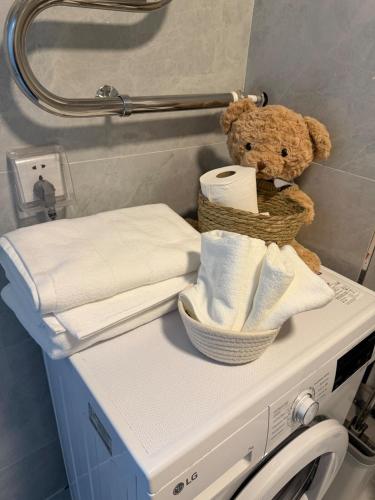 a teddy bear sitting on top of a washing machine at Cozy Apartment newly furnished in Ulaanbaatar