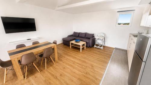 a living room with a couch and a table at Šumadijski Pogled in Pružatovac