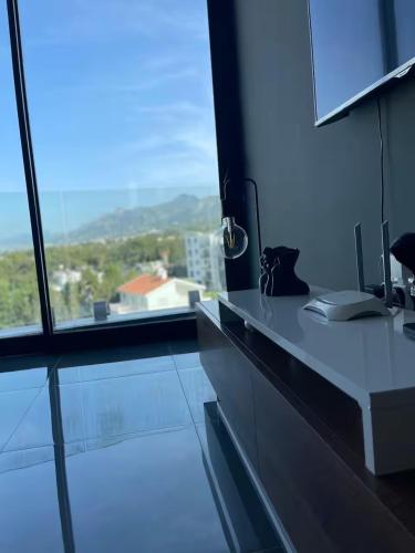 a kitchen with a counter and a large window at Hunz Homes in Ayii Trimithias