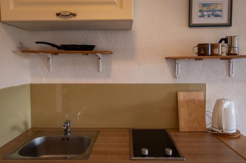 a kitchen with a sink and a counter top at Štanjelski Razgledi AR in Štanjel