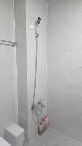 a bathroom with a shower and a toilet in it at Dear, U in Gyeongju