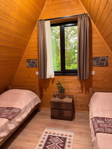 a bedroom with two beds and a window at NerNeri Cottage Martvili in Martvili