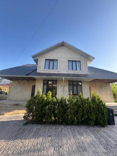 a large house with a roof on a brick driveway at Коттедж в Азиа Палас in Chon-Sary-Oy