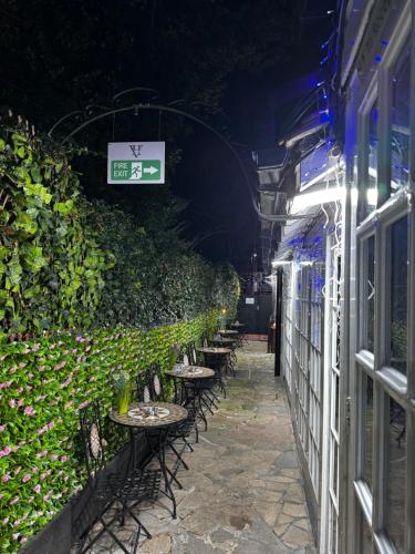 a row of tables and chairs in an alley at Verve Hotel in Bedford
