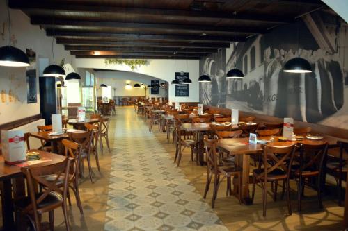 a row of tables and chairs in a restaurant at Kyjovský pivovar - hotel, restaurace, pivní lázně in Kyjov