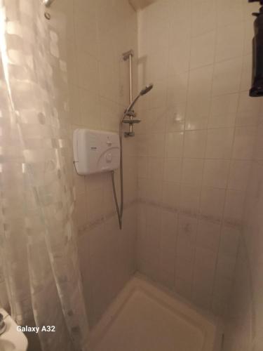 a bathroom with a shower with a shower curtain at Fishing in Foxford