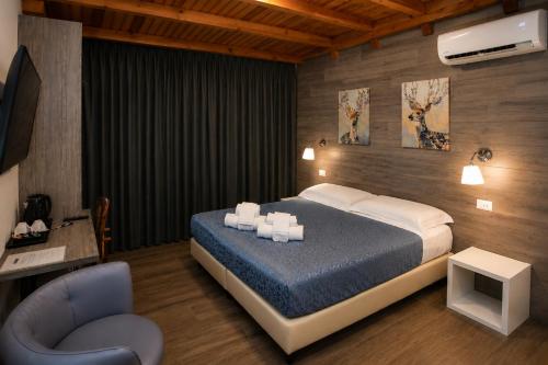 a bedroom with a king sized bed and a chair at VillaCuore in Tavernerio