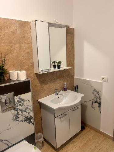 a bathroom with a sink and a mirror at D&D New Residence in Piteşti