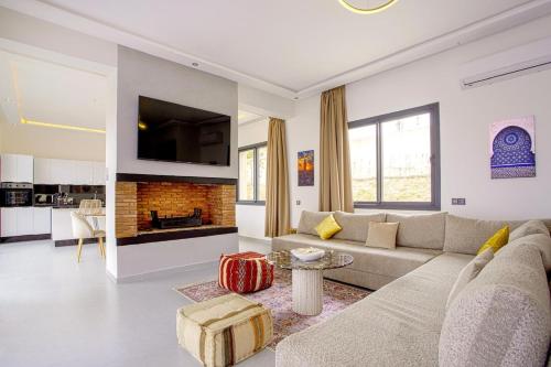 a living room with a couch and a fireplace at Villa Ines with heated pool & panoramic views in El Aïn