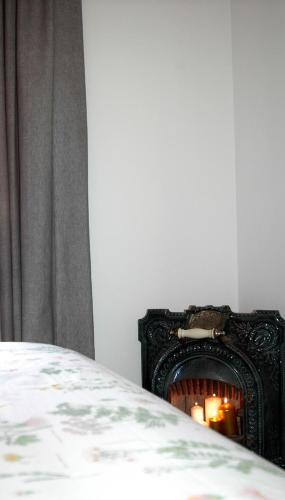 a bedroom with a bed and a fireplace at Groc Rooms in La Seu d'Urgell