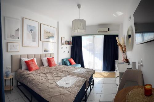 a bedroom with a bed with red pillows on it at Green Sea Studio in Rethymno