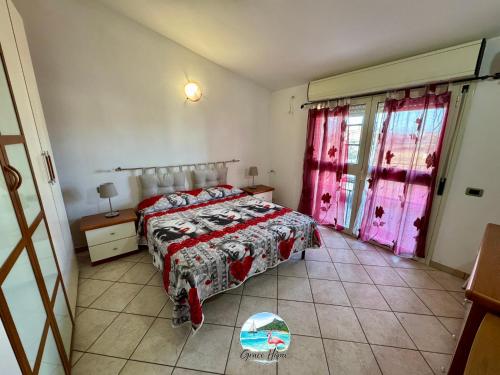 a bedroom with a bed and pink curtains at Grace Home in Assemini