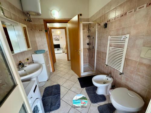 a bathroom with a toilet and a sink and a shower at Grace Home in Assemini