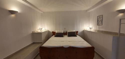 a bedroom with a large bed with two pillows on it at Traumhaftes Apartment mit Pool in Altea