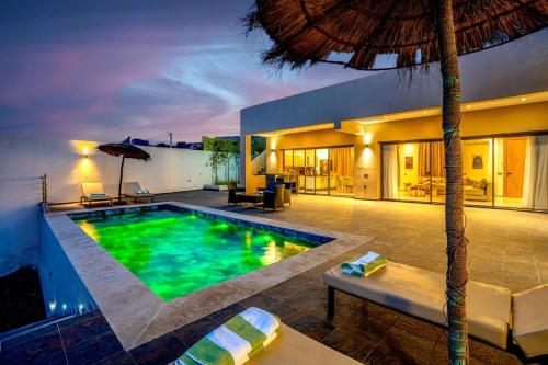 a swimming pool in the middle of a house at Villa Ines with heated pool & panoramic views in El Aïn