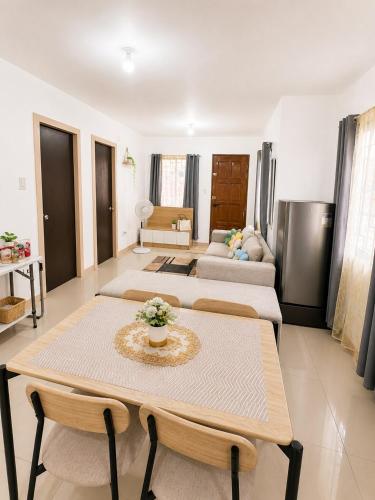 a living room with a table and a couch at Balay in Butuan