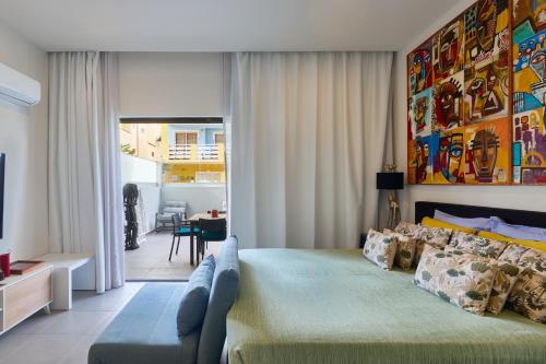 a bedroom with a large bed and a couch at Edificio Lux's - Apartamentos Tubarão in Santa Maria