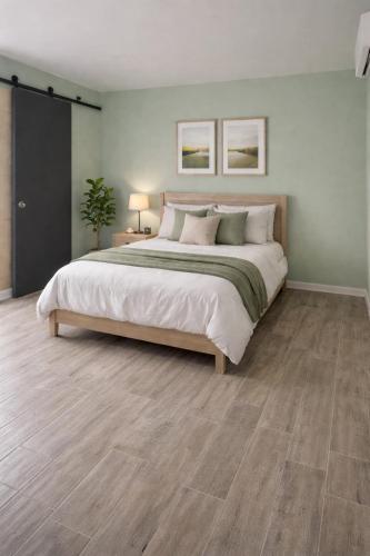 a large bedroom with a large bed and wood floors at La Perpignanaise in Perpignan