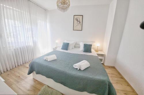 a bedroom with a large bed with two pillows on it at Villa Marante with heated private pool in Podstrana