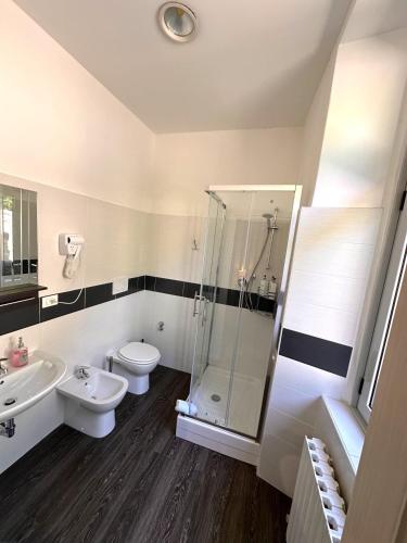 a bathroom with a shower and a toilet and a sink at Villa Tergeste in Trieste
