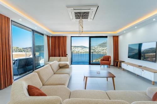 a living room with a couch and a table at Villa Mavrem in Bezirgân