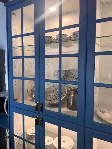 a blue cabinet filled with plates and dishes at Dalmatian rustic house in Petrcane