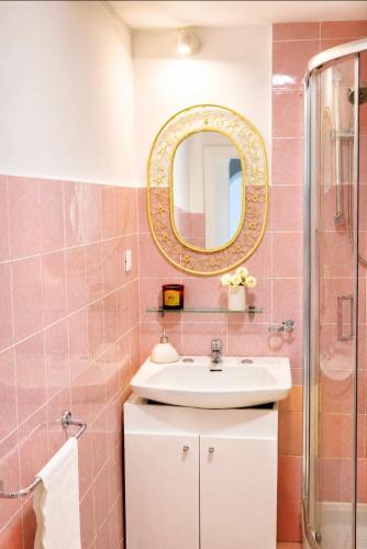 a bathroom with a sink and a mirror at Casa Intiso - Two double bedroom apartment in Positano
