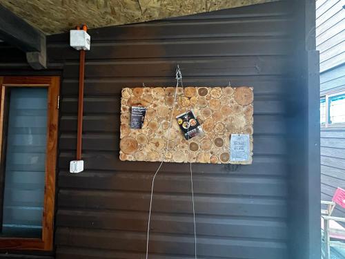 a wall of a house with a cork board at Hostal Palguin 261 in Pucón