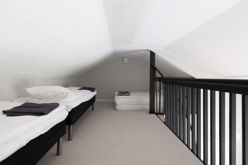 two beds in a room with a staircase at Villa MiaEmilia A in Espoo