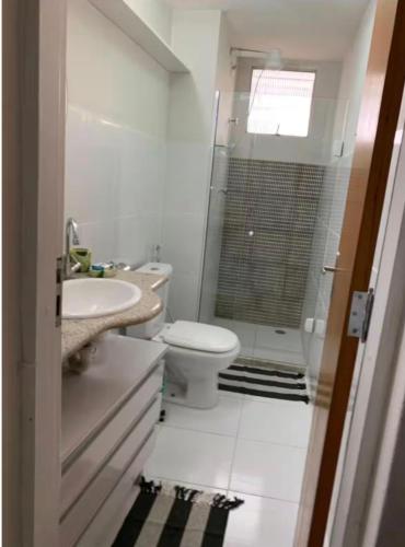 a bathroom with a toilet and a sink and a shower at Praia da Costa próx da Praia in Vila Velha