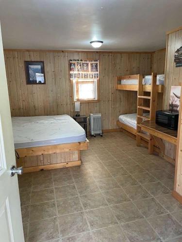 a bedroom with two bunk beds and a window at Family Cabin full bath in Gaines