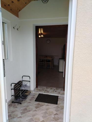 a hallway with a door open to a room with a table at Holiday Home Apartman Aco in Žabljak