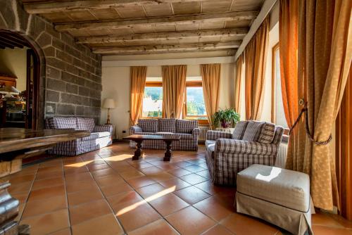 a living room with couches and a table at Hotel Bellavista in Abetone