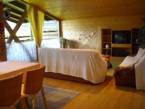 a living room with a couch and a table and chairs at Ferienwohnung Barbara Mair in Dölsach