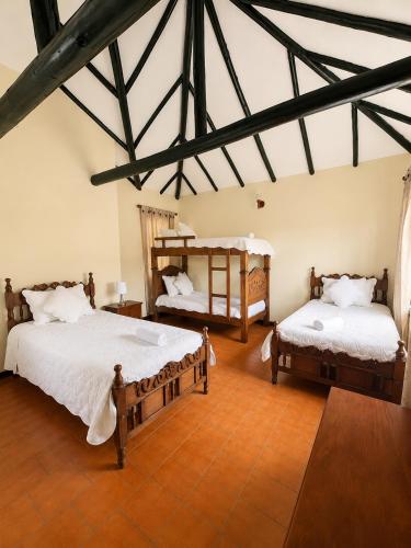a bedroom with two beds in a room at Hotel Altair in Villa de Leyva