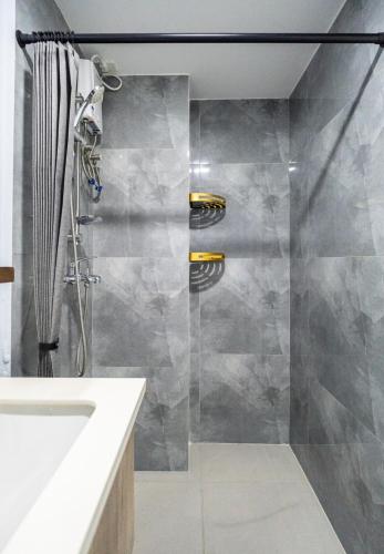 a bathroom with a shower and a sink at Lumiere Prime Studio - Mactan Pool Escape in Pajak