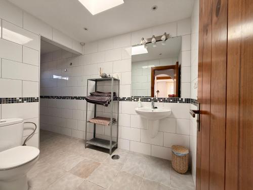 a bathroom with a toilet and a sink at Casa Joanna Lanzarote in Nazaret
