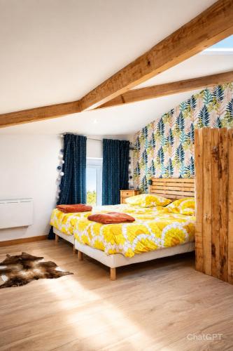 a bedroom with two beds and a window at Le pat' toit in Aurec-sur-Loire
