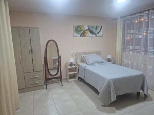 a bedroom with a bed and a mirror at casa completa e independiente en 2 piso in Antofagasta