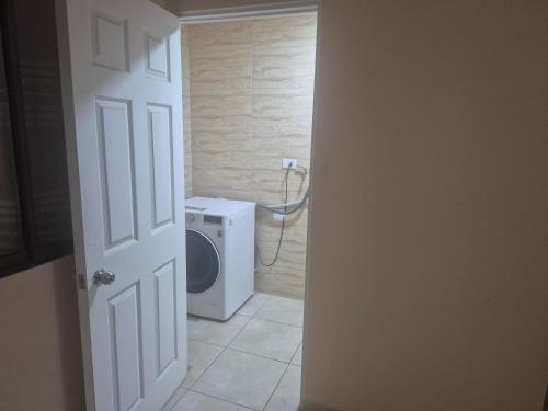 a bathroom with a toilet and a washing machine at casa completa e independiente en 2 piso in Antofagasta