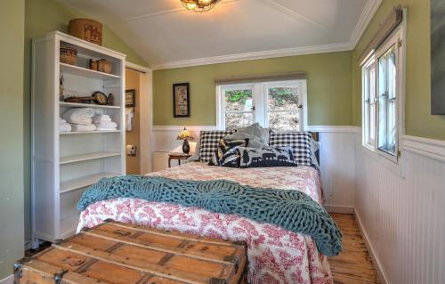 a bedroom with a bed and a window at Red Bungalow Vallecito Studio Cabin near Durango, CO in Bayfield