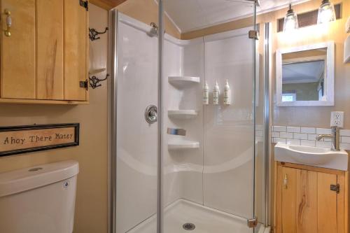 a bathroom with a shower and a sink at Red Bungalow Vallecito Studio Cabin near Durango, CO in Bayfield