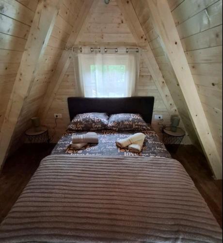 a bedroom with a large bed in a attic at Lake house Andrej & Andrea in Kuside