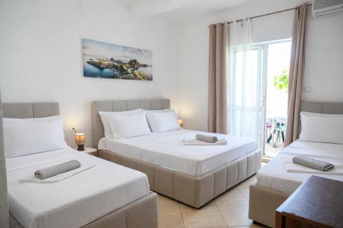 a hotel room with two beds and a balcony at Beach Walk Apartments in Ulcinj