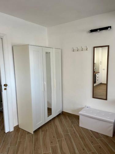 a room with a white cabinet and a mirror at Apartment, Sulina's House 2 in Campofelice di Roccella