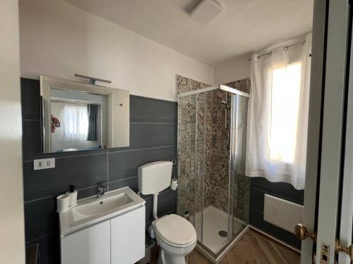 a bathroom with a toilet and a sink and a shower at Apartment, Sulina's House 2 in Campofelice di Roccella