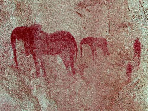 a painting of two horses on a wall at Ai Aiba - The Rock Painting Lodge in Omaruru