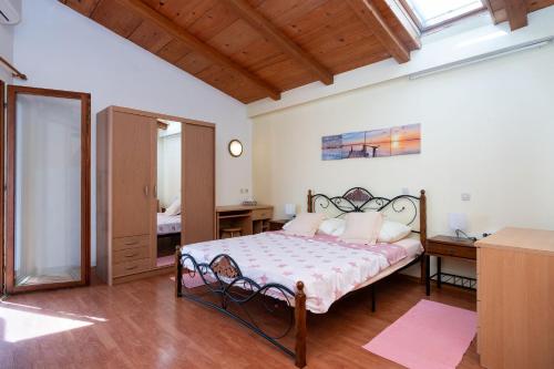 a bedroom with a bed and a desk and a window at Apartments Vrtina in Igrane